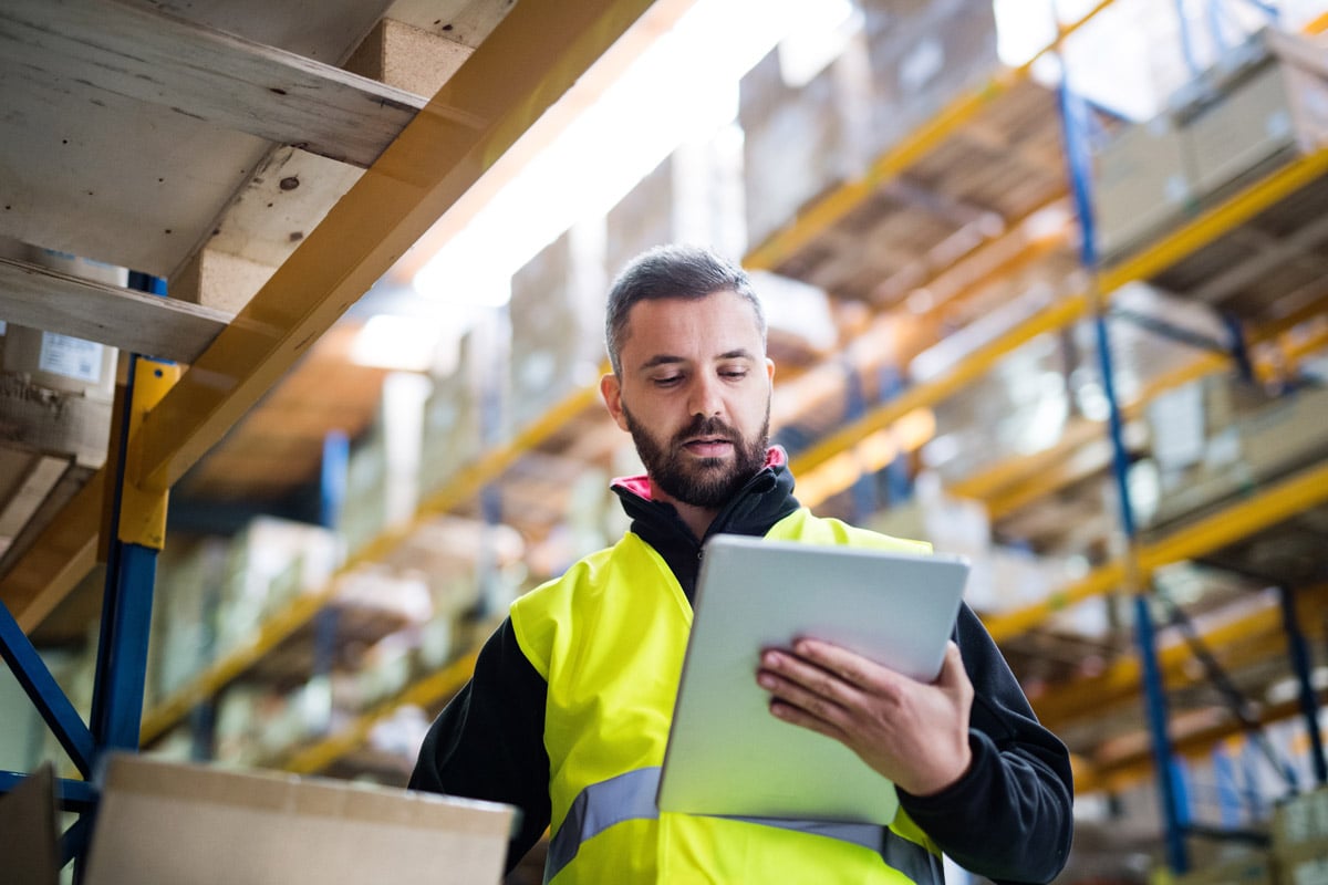 Warehouse worker reading tablet